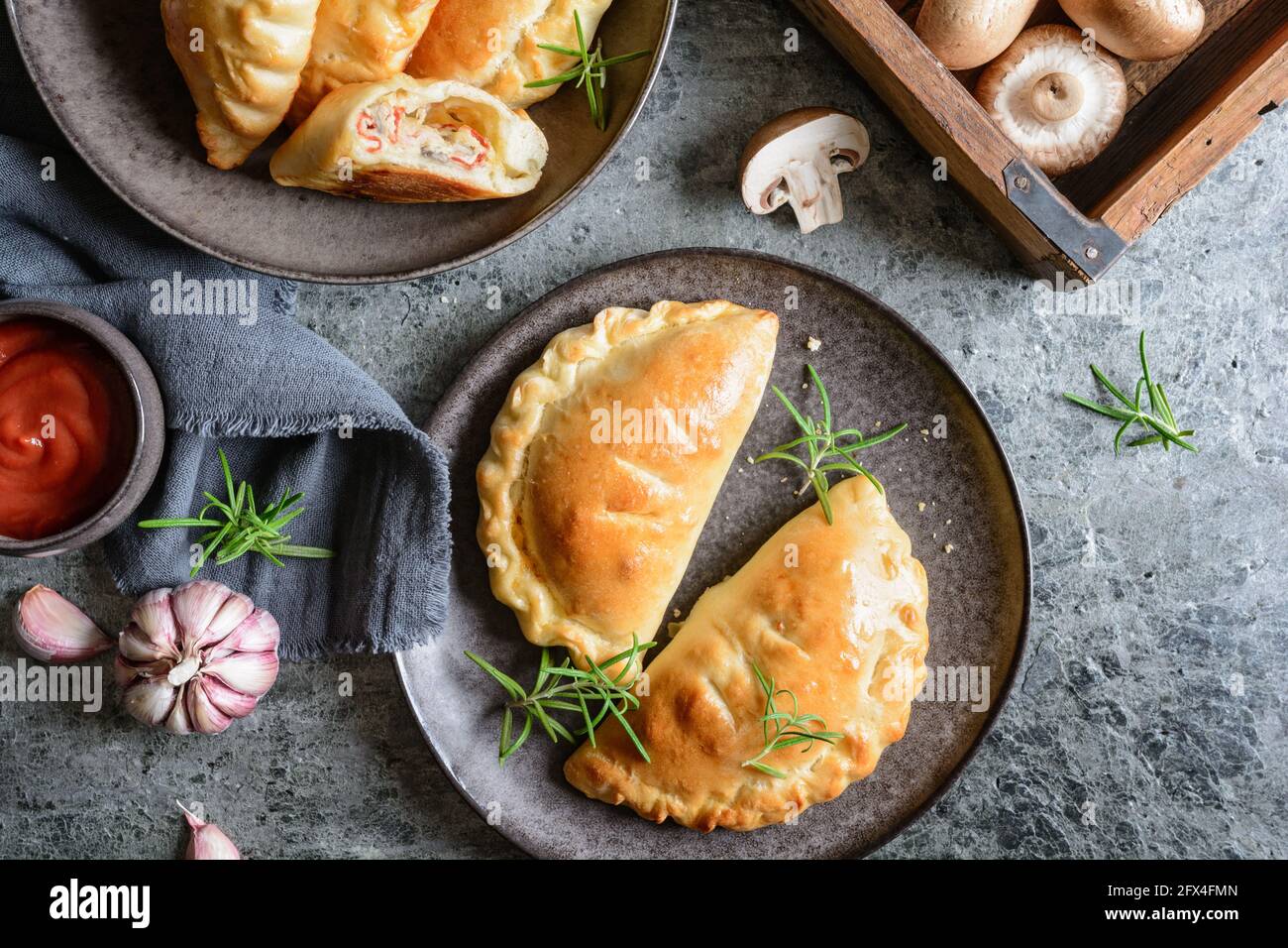 Homemade Calzone pizza stuffed with ham, ricotta, salami, cheese and