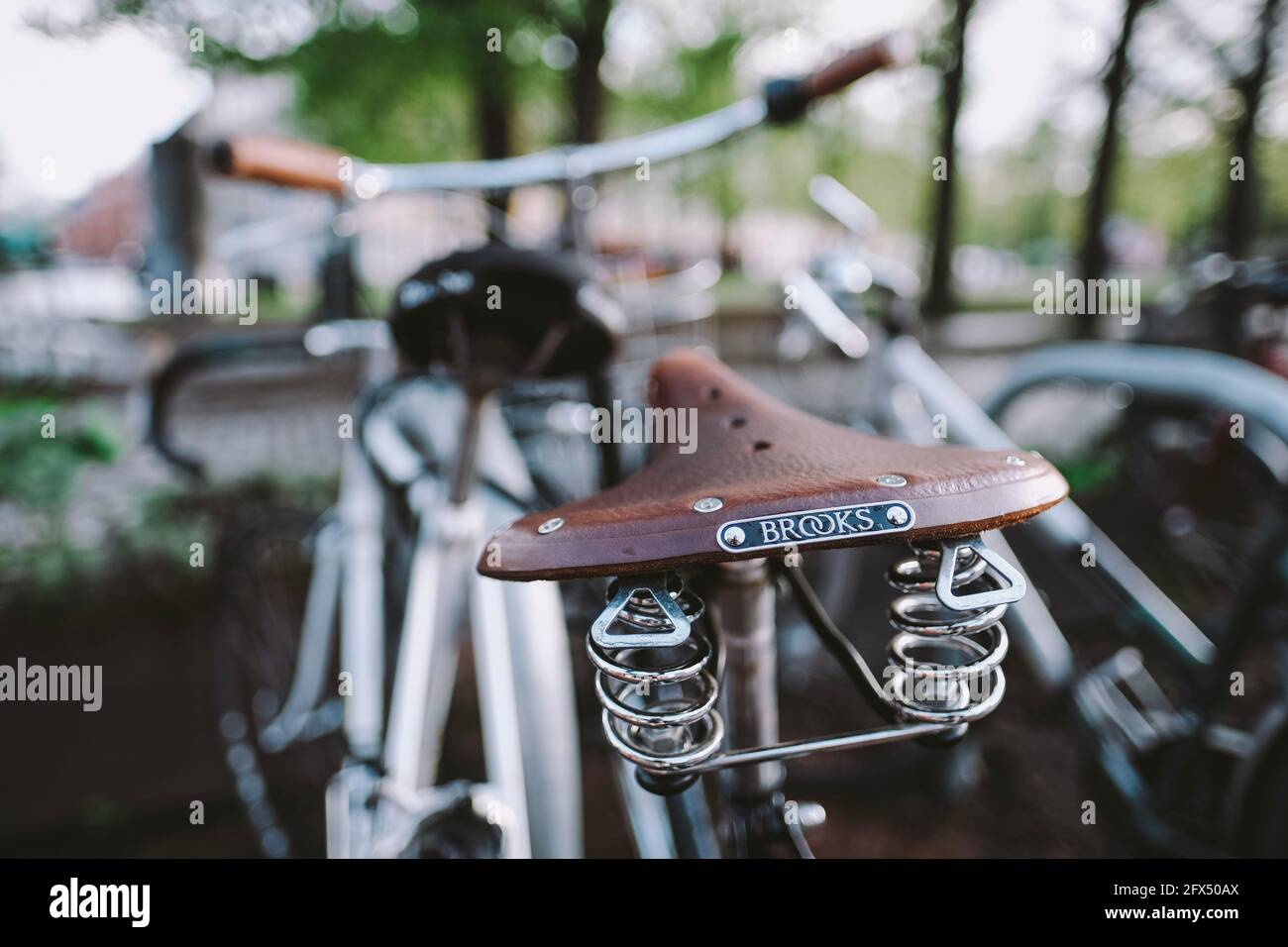 Oslo, Norway - 05/22/2021: Brooks bicycle leather seat at Sagene area in Oslo, Norway, Scandinavia with a colourful background in front of public park Stock Photo