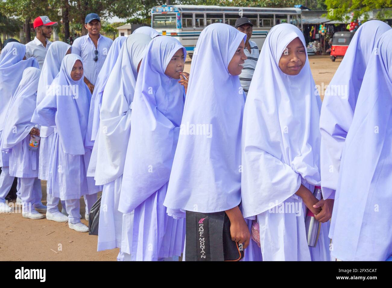 Group of Sri Lankan Muslim schoolgirls wearing lilac hijab on a day trip to Pasikuda Beach