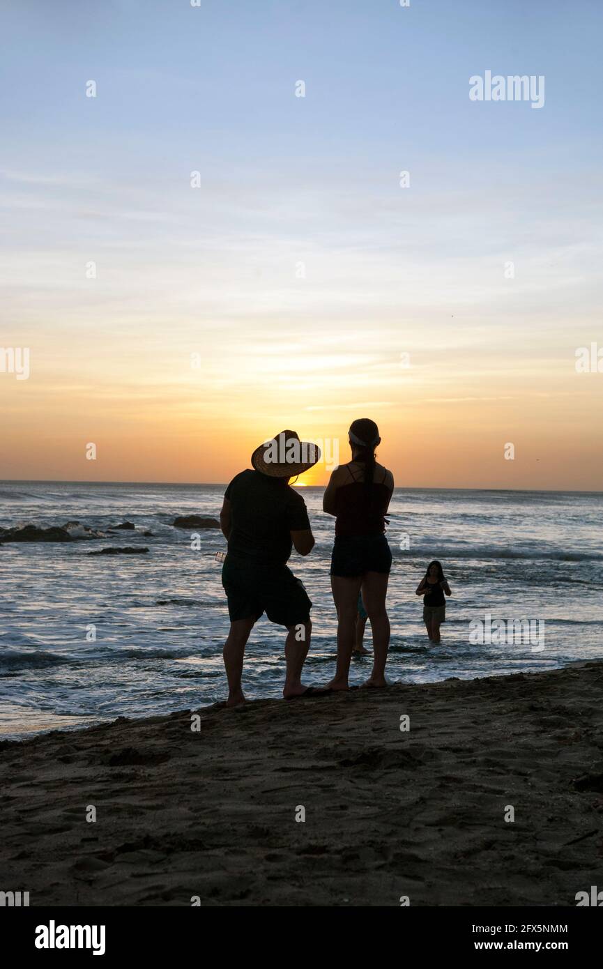 People watching the sunset in Tamarindo, Costa Rica, Central America Stock Photo