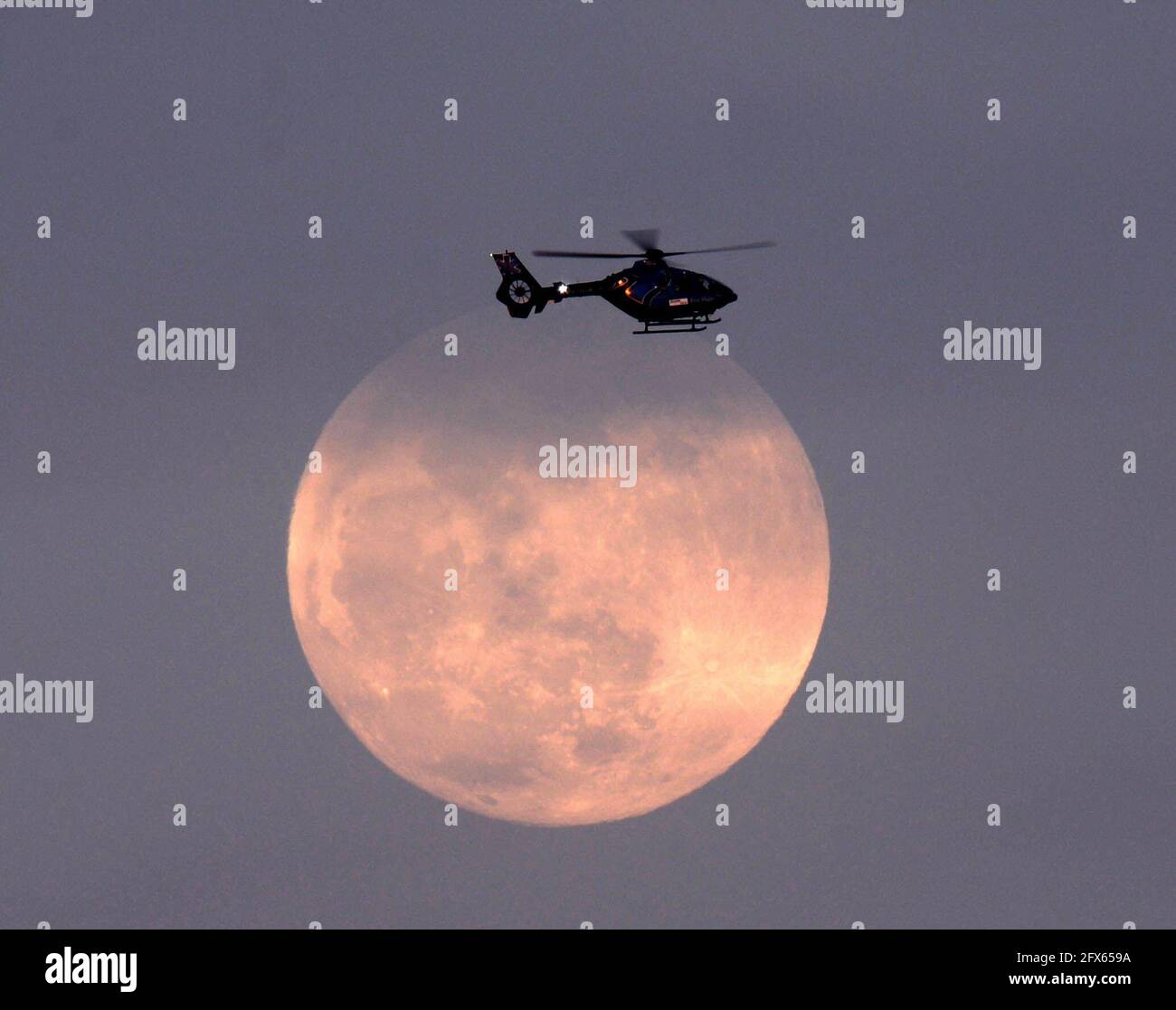 Melbourne. Brevard County, Florida. USA. May 25, 2021.Melbourne's Health First Air Medical Transport Helicopter passing the full moon. Photo Credit: Julian Leek/Alamy Live News Stock Photo