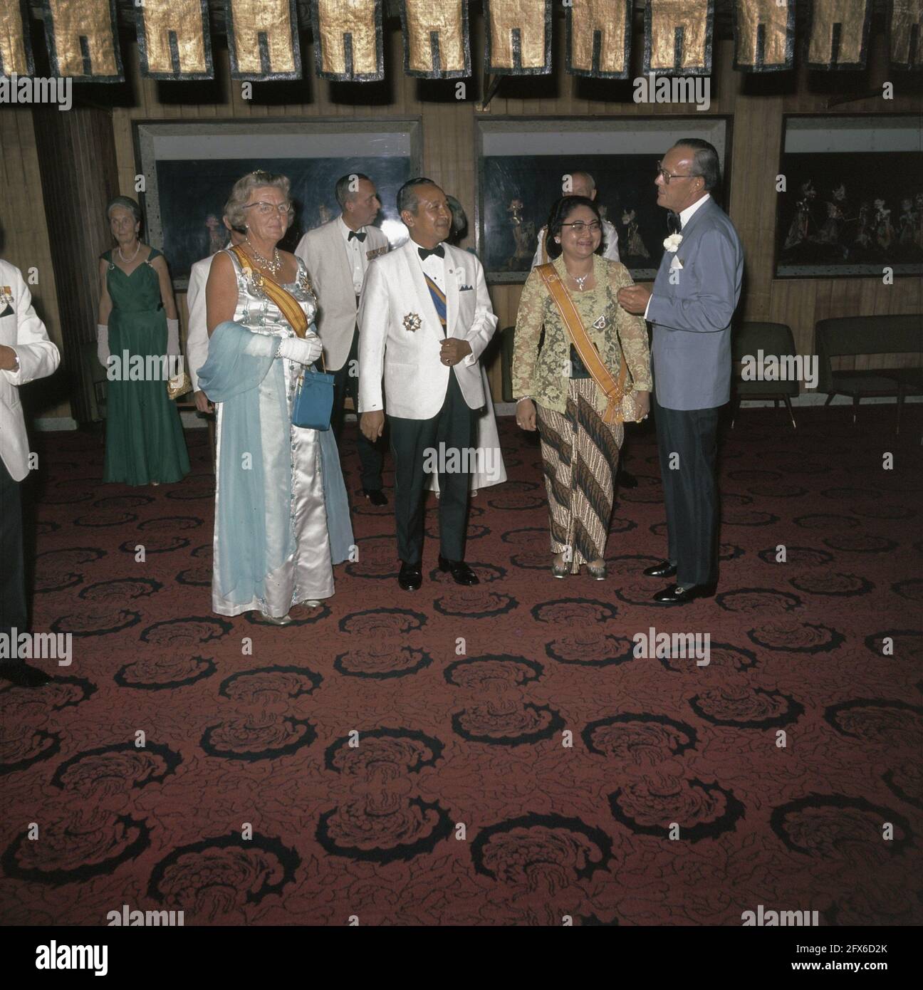 The royal couple at a gala meeting with President Suharto and his wife,  probably at the home of Ambassador Scheltema, August 27, 1971, party dress,  state visits, The Netherlands, 20th century press