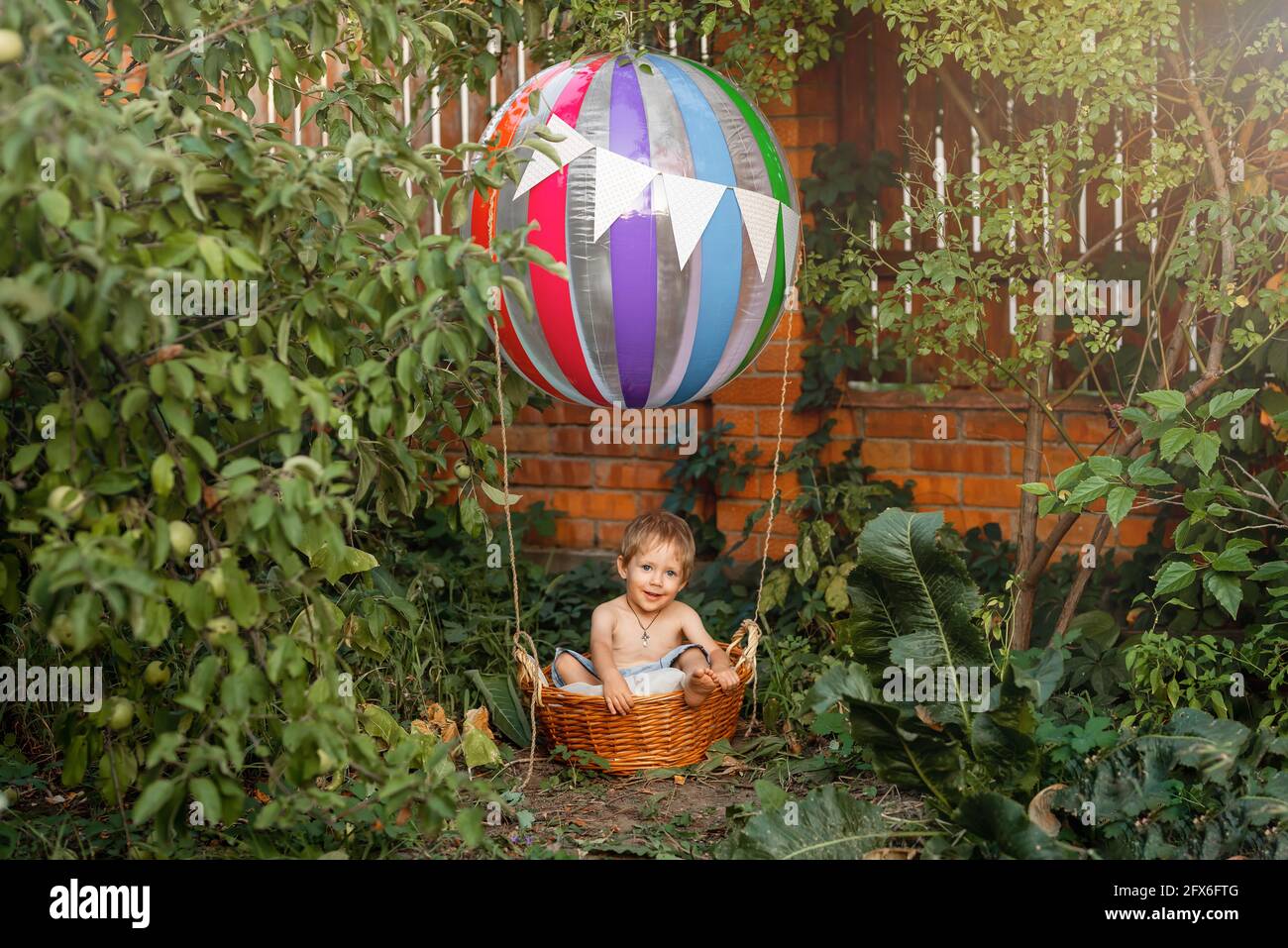 Preschool boy traveling. Child playing in pretend hot air balloon. Stock Photo
