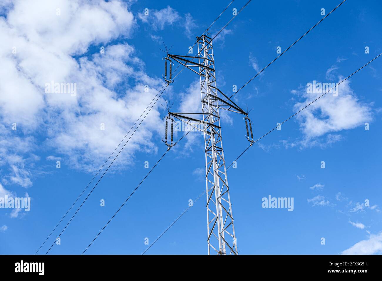 High voltage pole on blue sky Stock Photo - Alamy