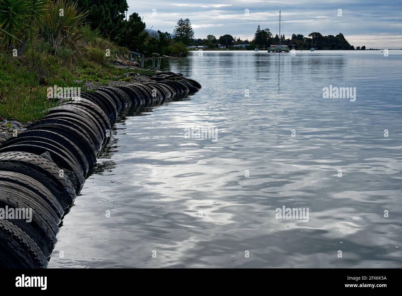 Old tires being used as a sea wall to combat rising sea levels, Trewavas Street, Motueka, Tasman region, New Zealand. Stock Photo