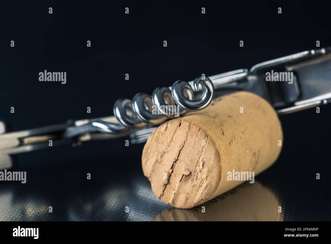Close-up of corkscrew with cork Stock Photo