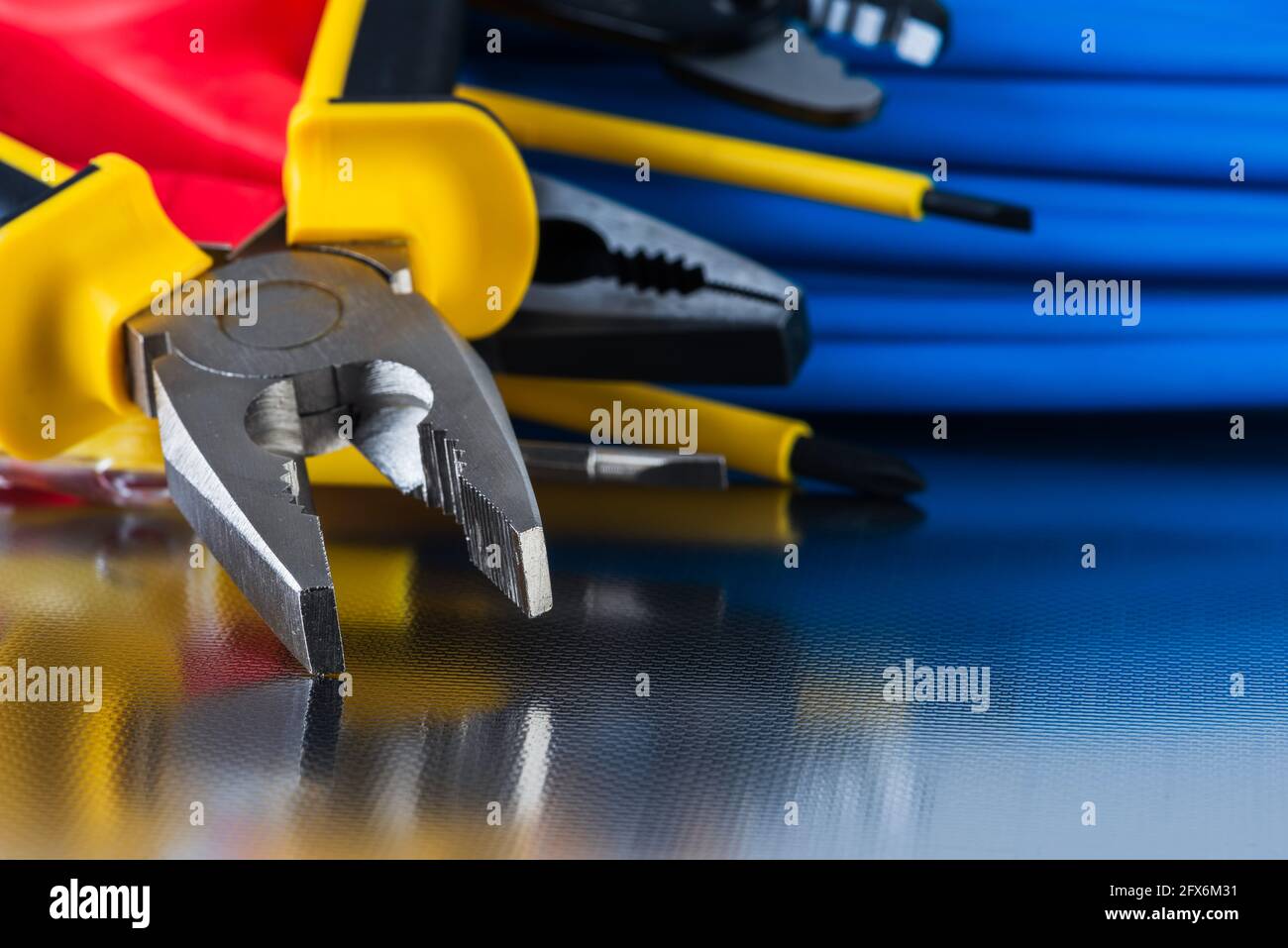 Electrical installation tool and cabling close-up shiny workshop background Stock Photo