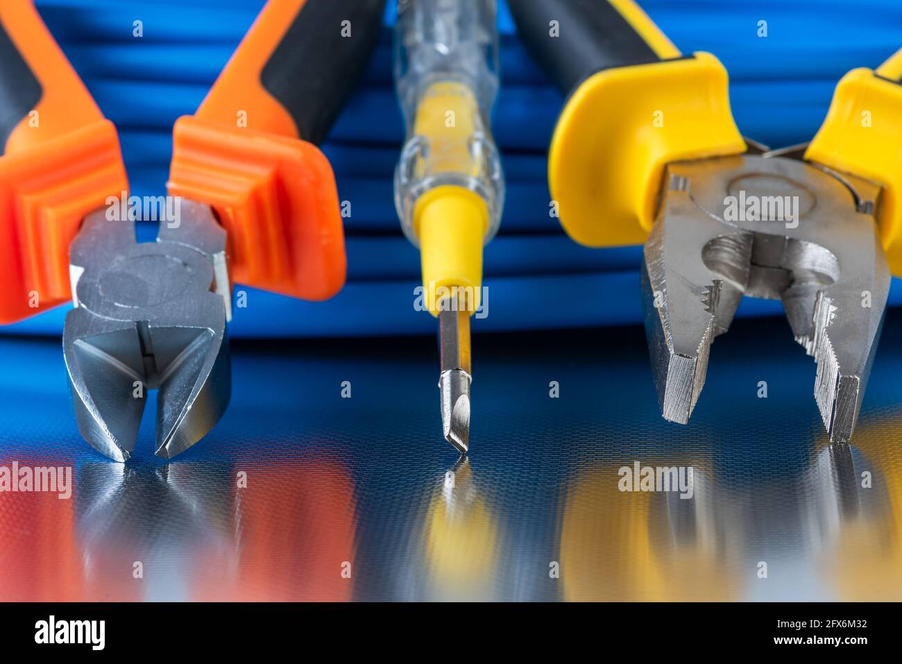 Electrical installation tool and cable wire close-up shiny workshop table Stock Photo