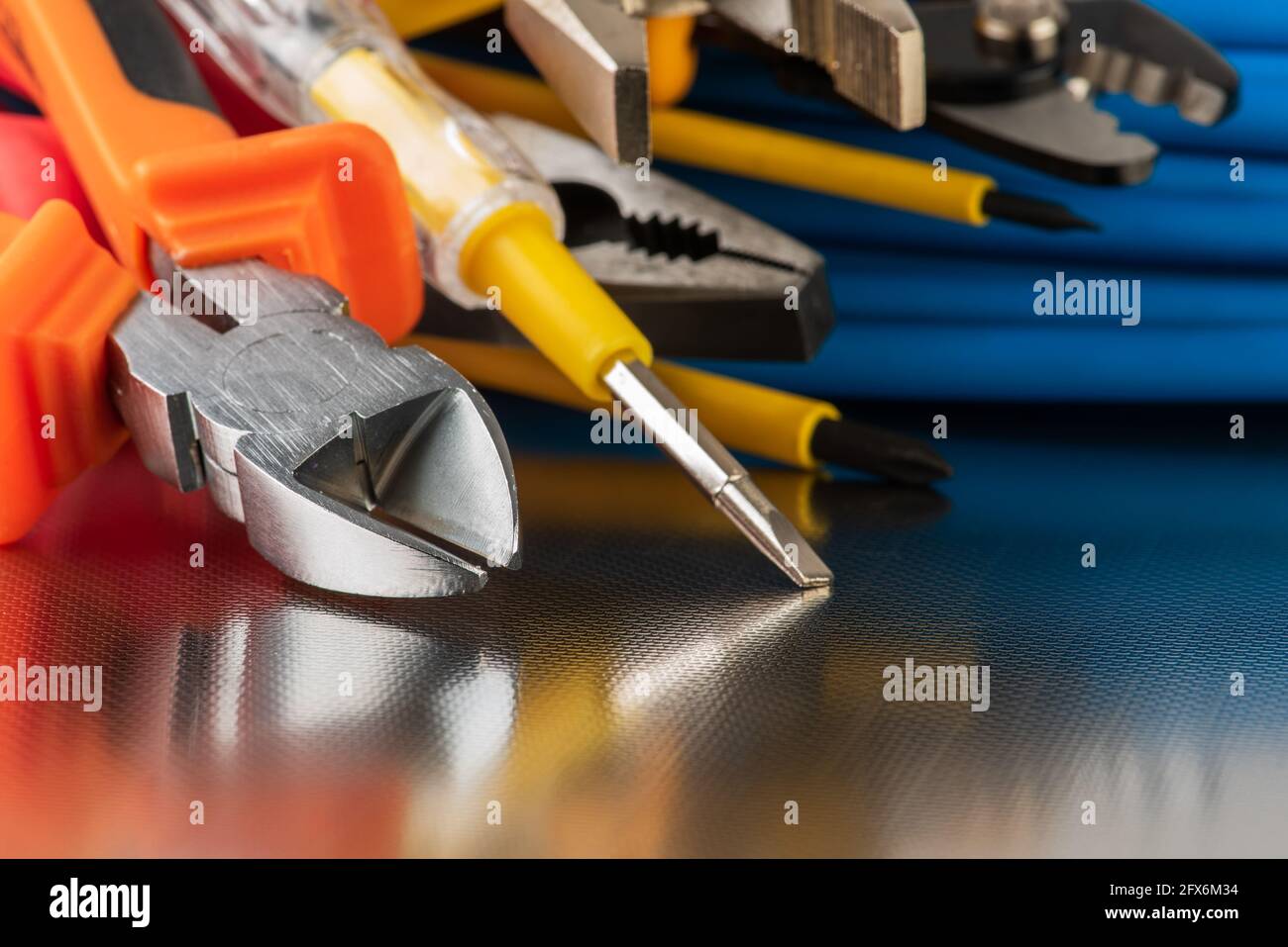 Electrical installation tool and cabling close-up shiny workshop background Stock Photo
