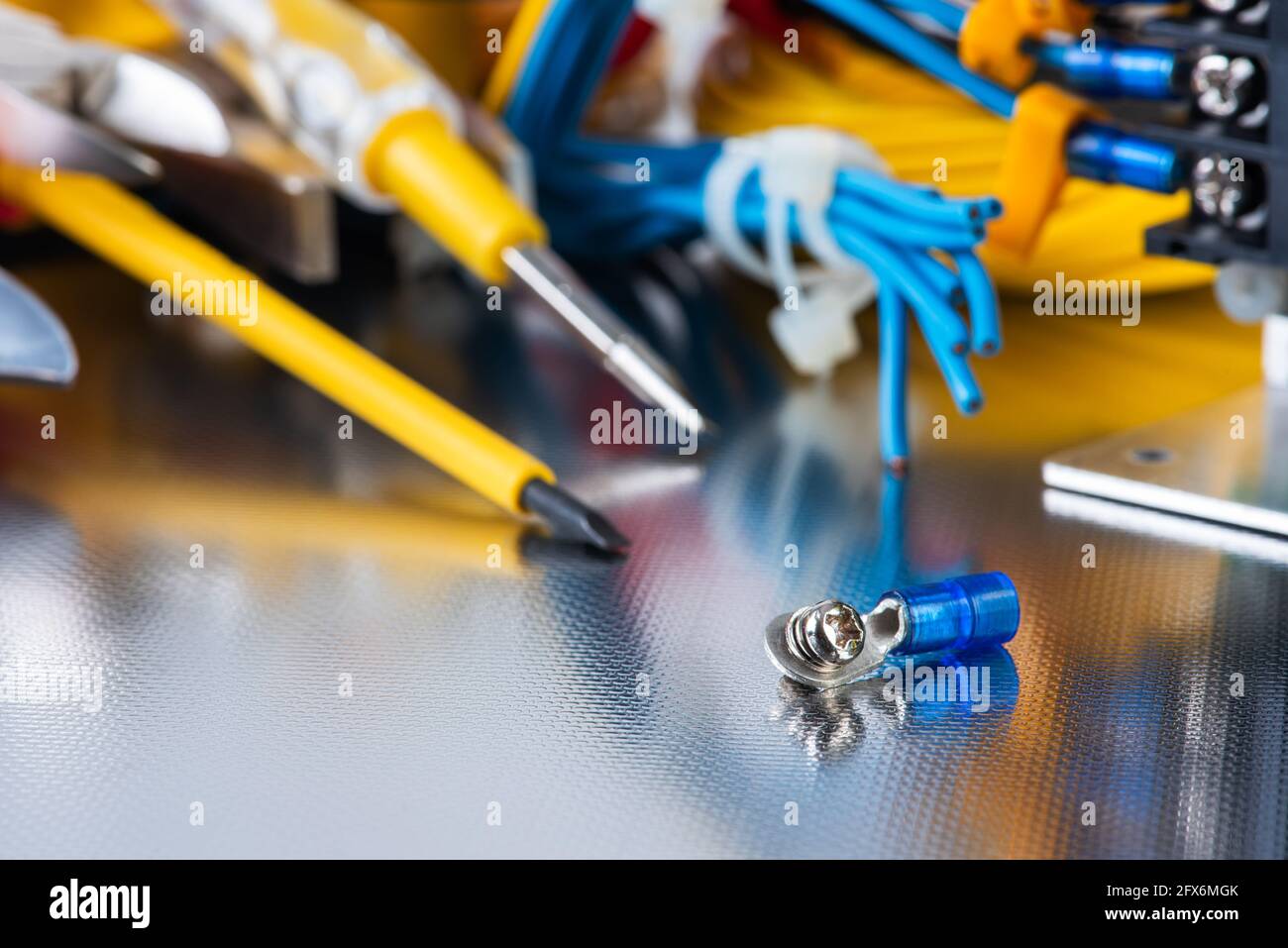 Set of electrical tools and equipment on a metal background, closeup
