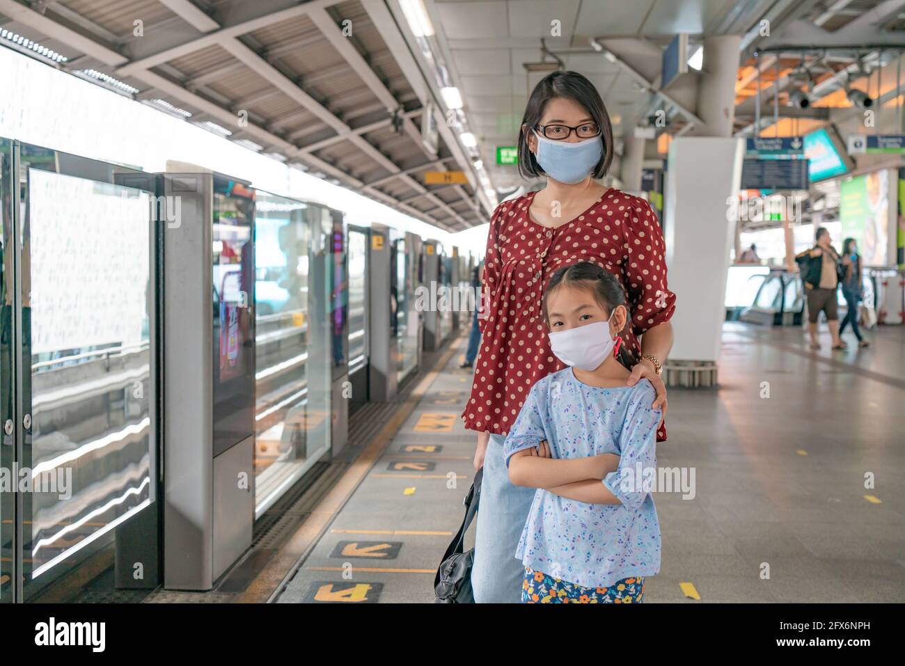 Bangkok, Thailand - Jul 07, 2020 : Portrait of Asian mother and little daughter on sky train station of Bangkok, Thailand. Mother and little daughter Stock Photo
