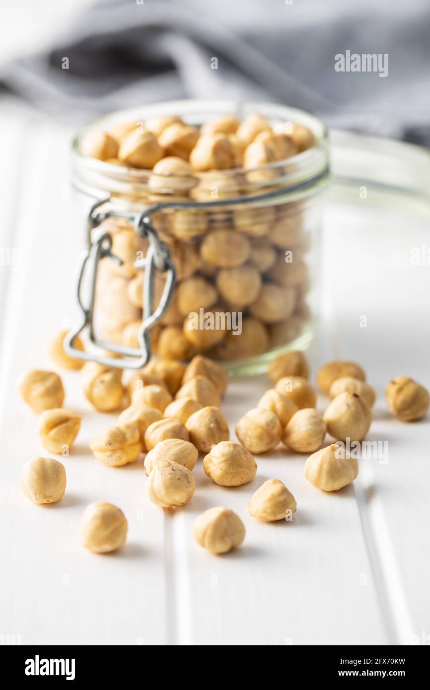 Peeled roasted hazelnut kernels in jar. Stock Photo