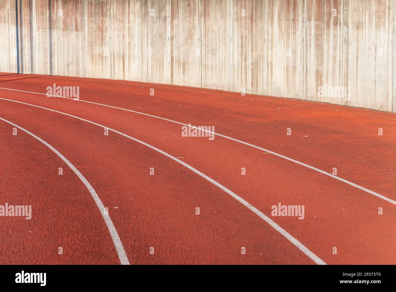 Part Red plastic track in the outdoor track and field stadium.Closeup. Stock Photo