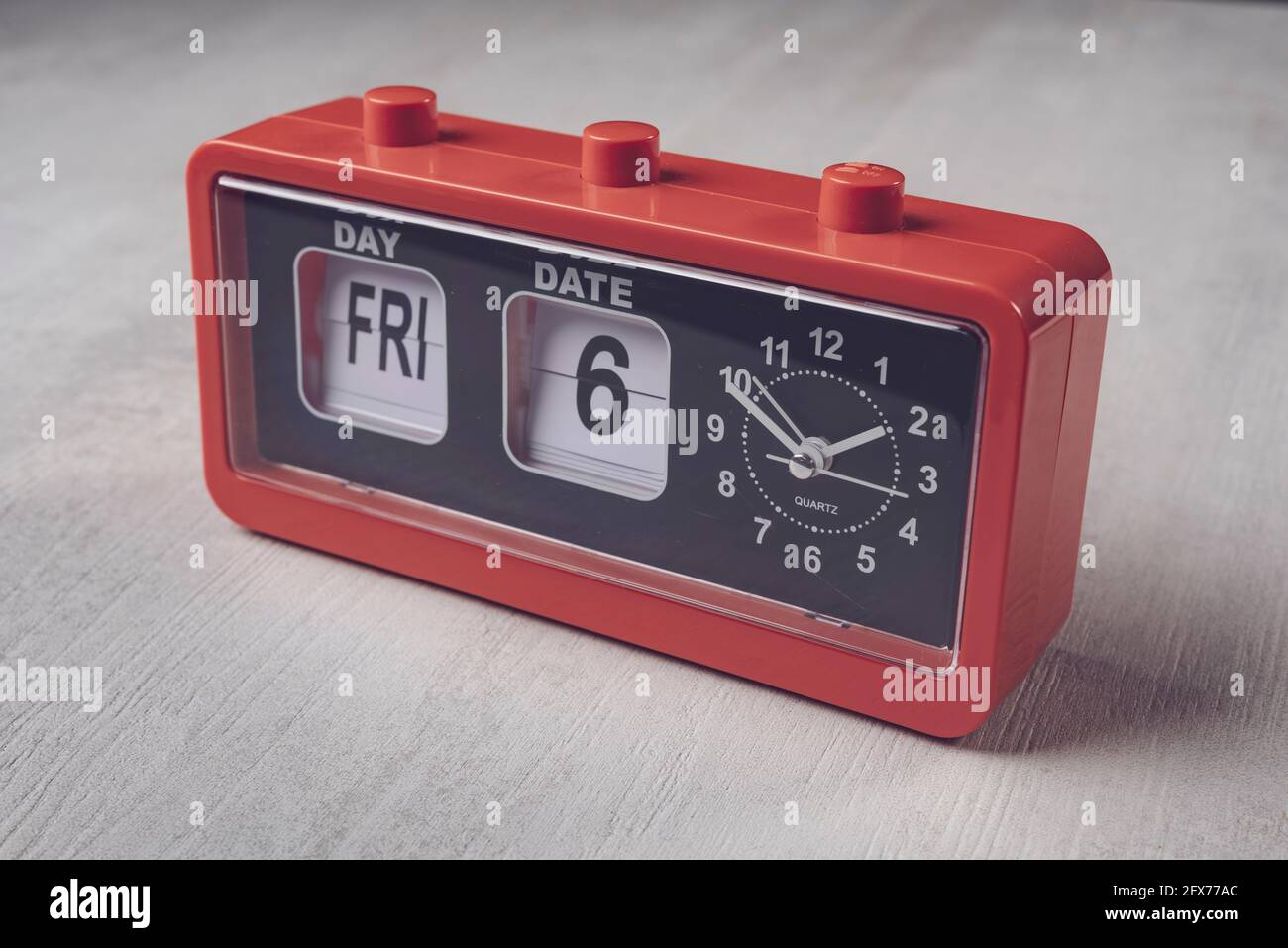 Vintage plastic alarm clock with calendar and buttons on top Stock