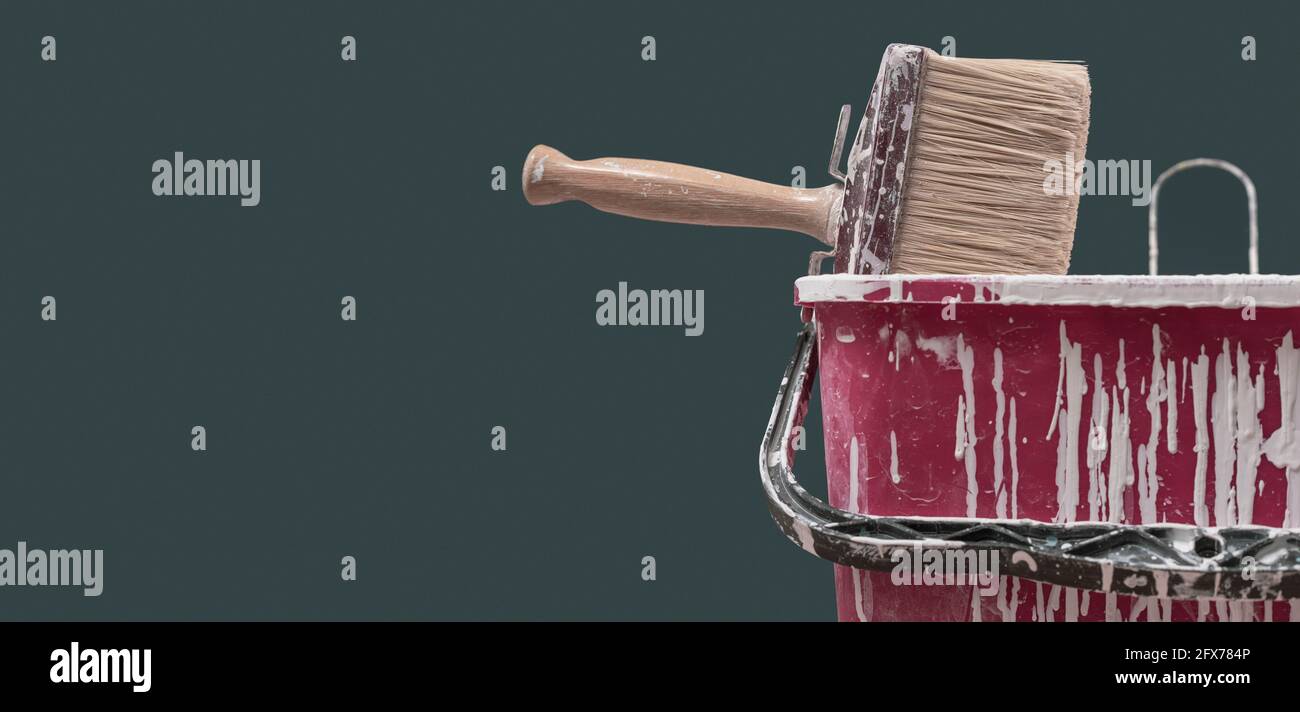 Brush and bucket with paint drops: home renovation and decoration ...