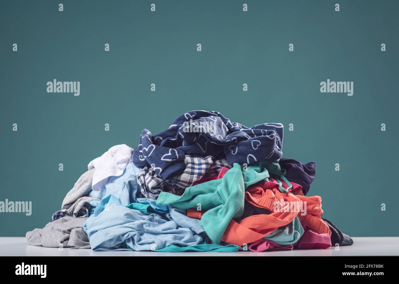 Heap of crumpled dirty clothes, laundry and household chores concept