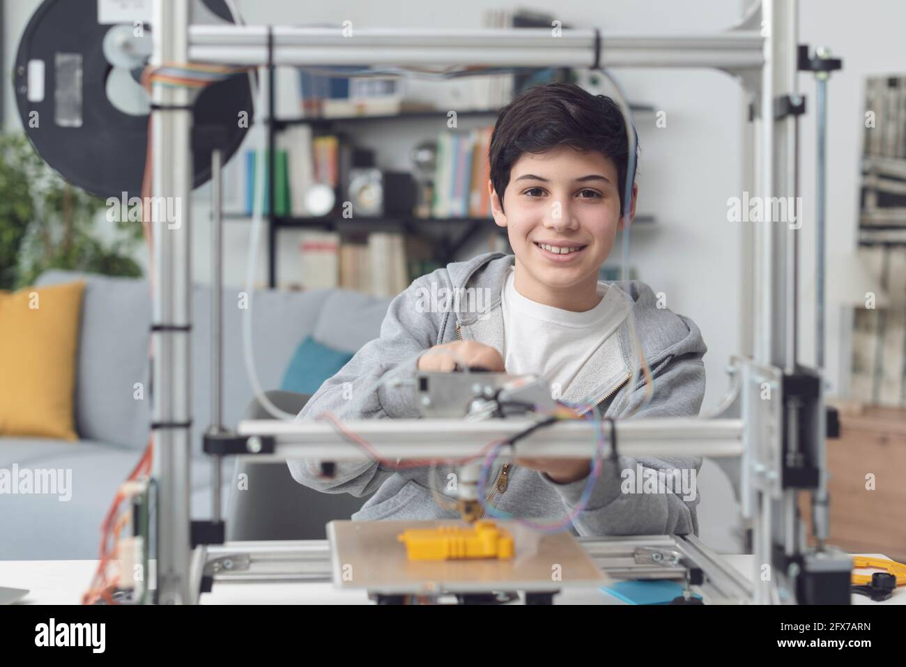 Smart young boy learning how to use a 3D printer at home, science and ...