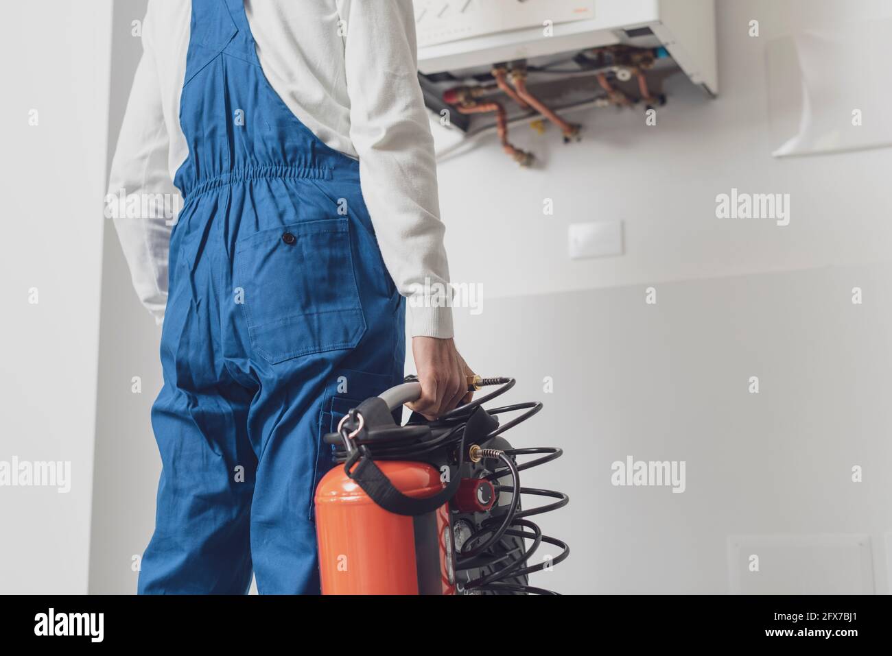 Plumber checking a boiler using professional tools, boiler servicing concept Stock Photo