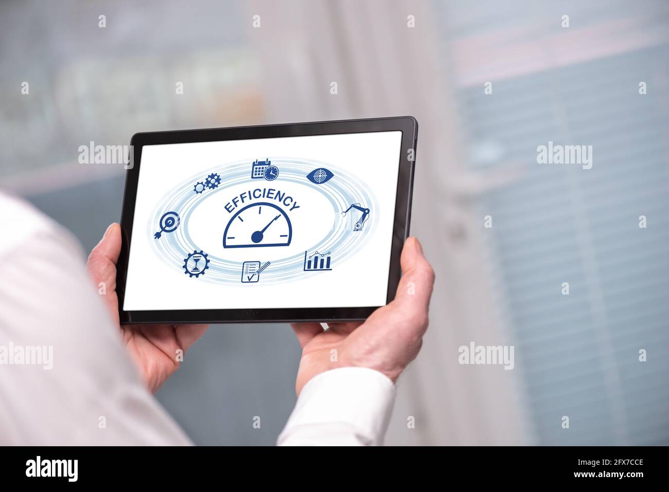 Efficiency concept shown on a tablet held by a man Stock Photo