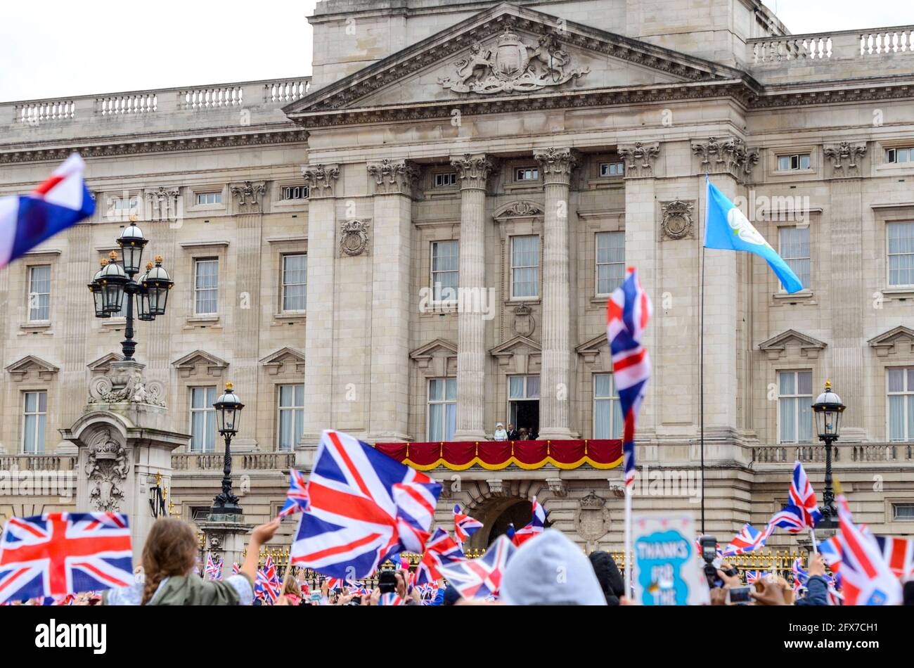 Crowds outside Buckingham Palace at the Queens Diamond Jubilee celebration in London, UK, with The Queen and family on the balcony in distance Stock Photo