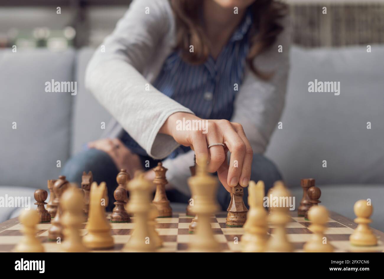 Woman moving chess piece hi-res stock photography and images - Alamy