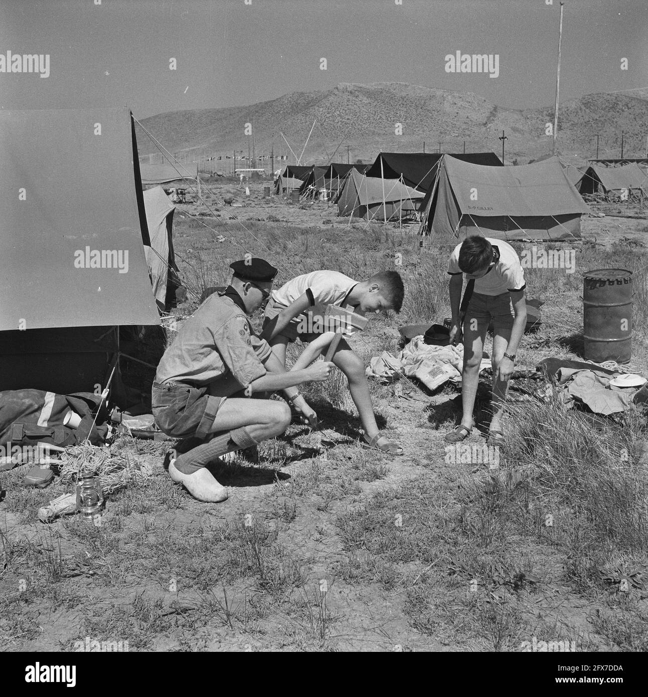 Jamboree 1963 at Marathon Greece. Ad Verhaar from Rotterdam putting up his tent on clogs, August 12 1963, tents, The Netherlands, 20th century press agency photo, news to remember, documentary, historic photography 1945-1990, visual stories, human history of the Twentieth Century, capturing moments in time Stock Photo