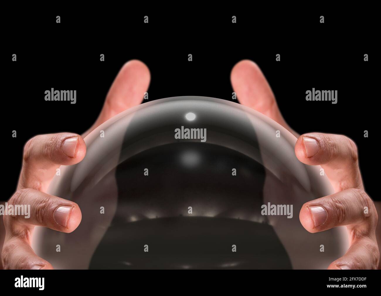A close up of a pair of male hands surrounding a crystal ball on an ...