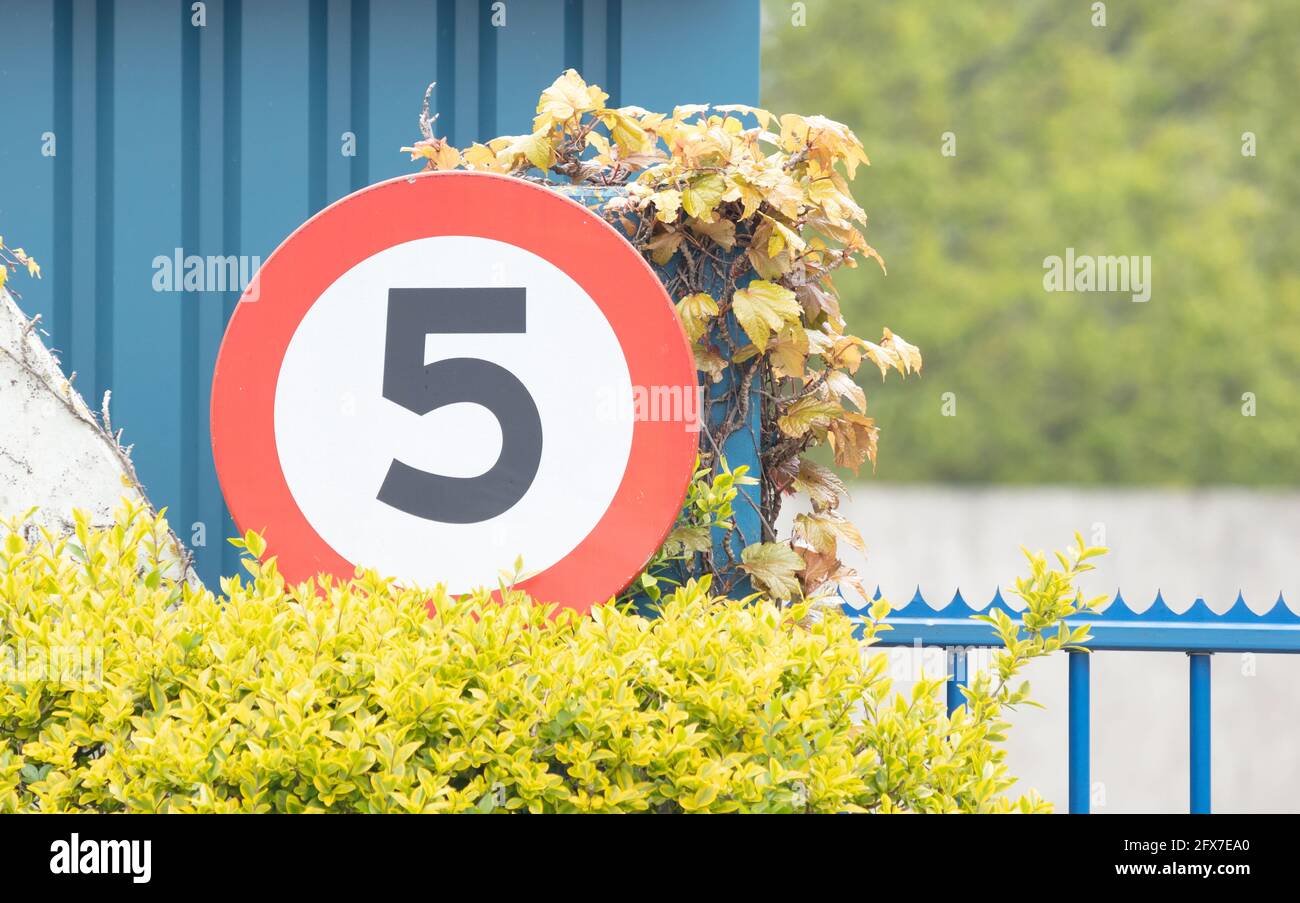 Speed limit of 5 kph mph Sign in an industrial area Stock Photo Alamy