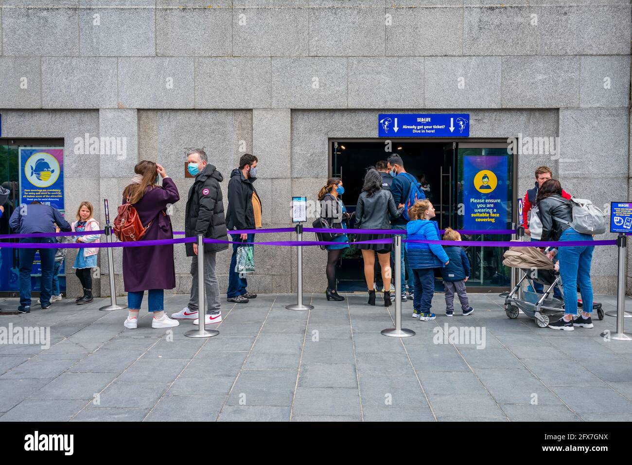 London.  A queue of visitors waiting to enter Sea Life London Aquarium as this popular attraction reopens after a long Covid-19 lockdown. Stock Photo