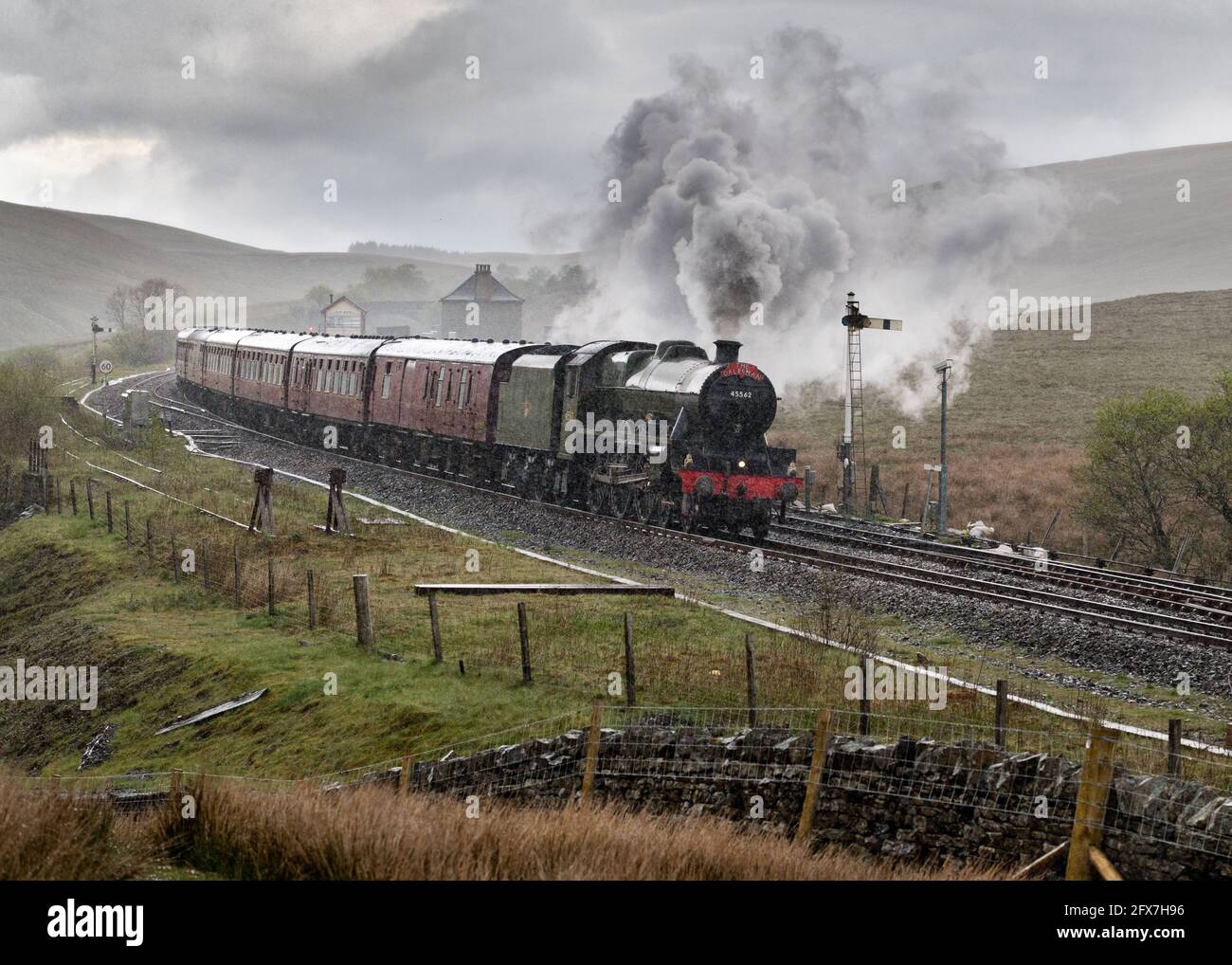Steam locomotive 'Alberta' battles through the pouring rain with 'The Pendle Dalesman' special train, Blea Moor, Settle-Carlisle railway. Stock Photo