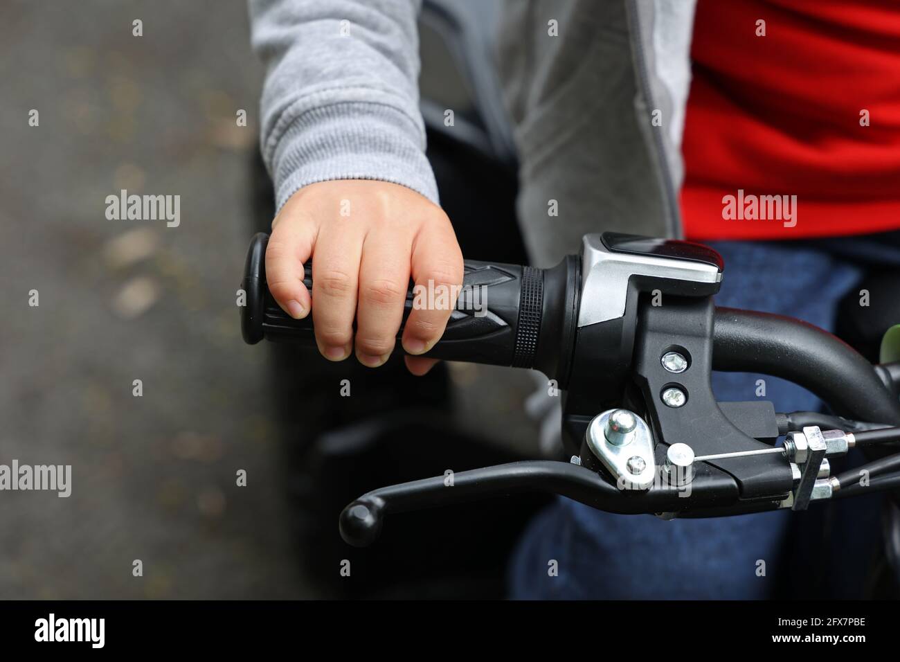 Childs hand on the steering wheel of a quad. Stock Photo