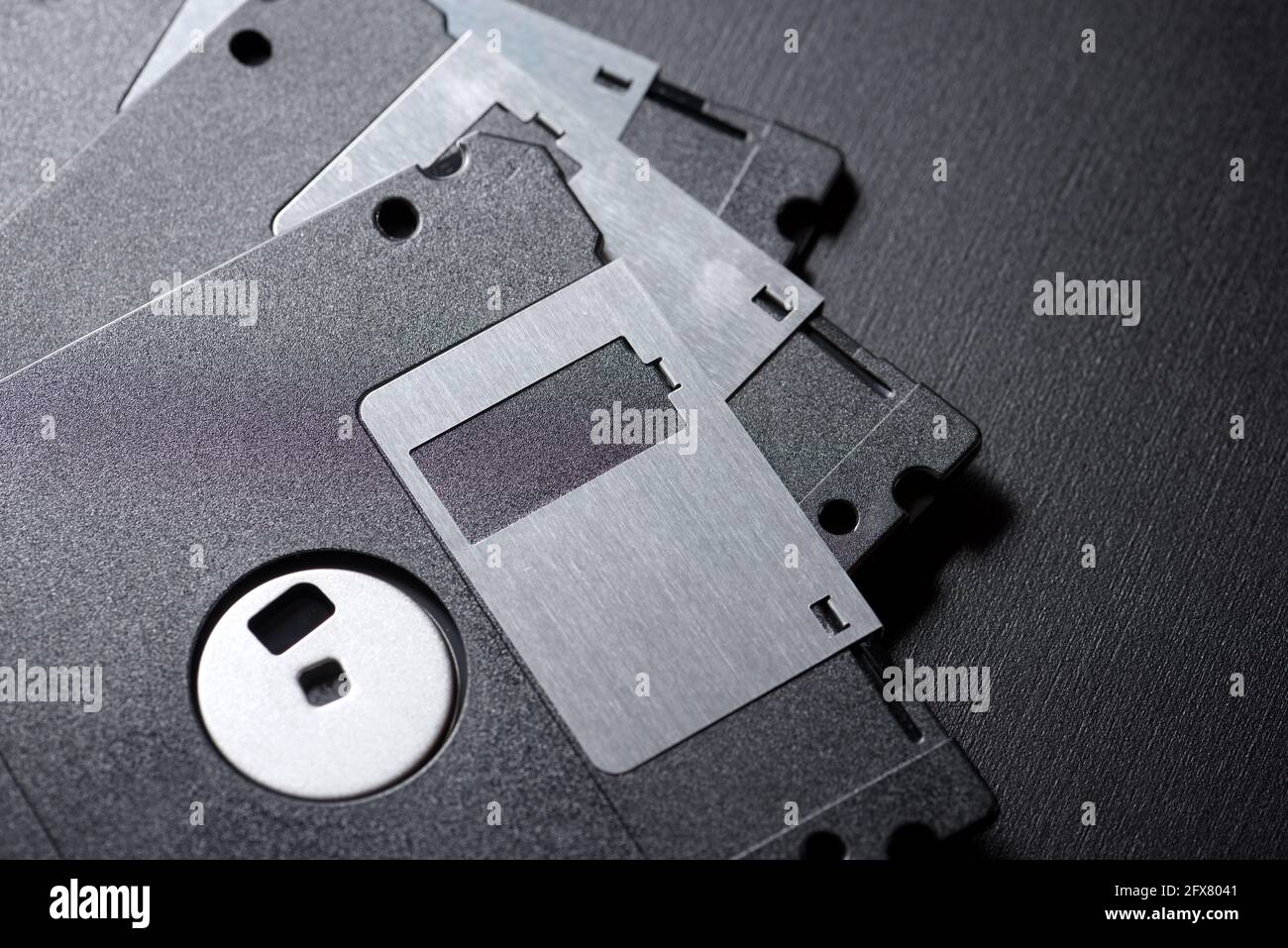 Old floppy disks on a black table. Stock Photo