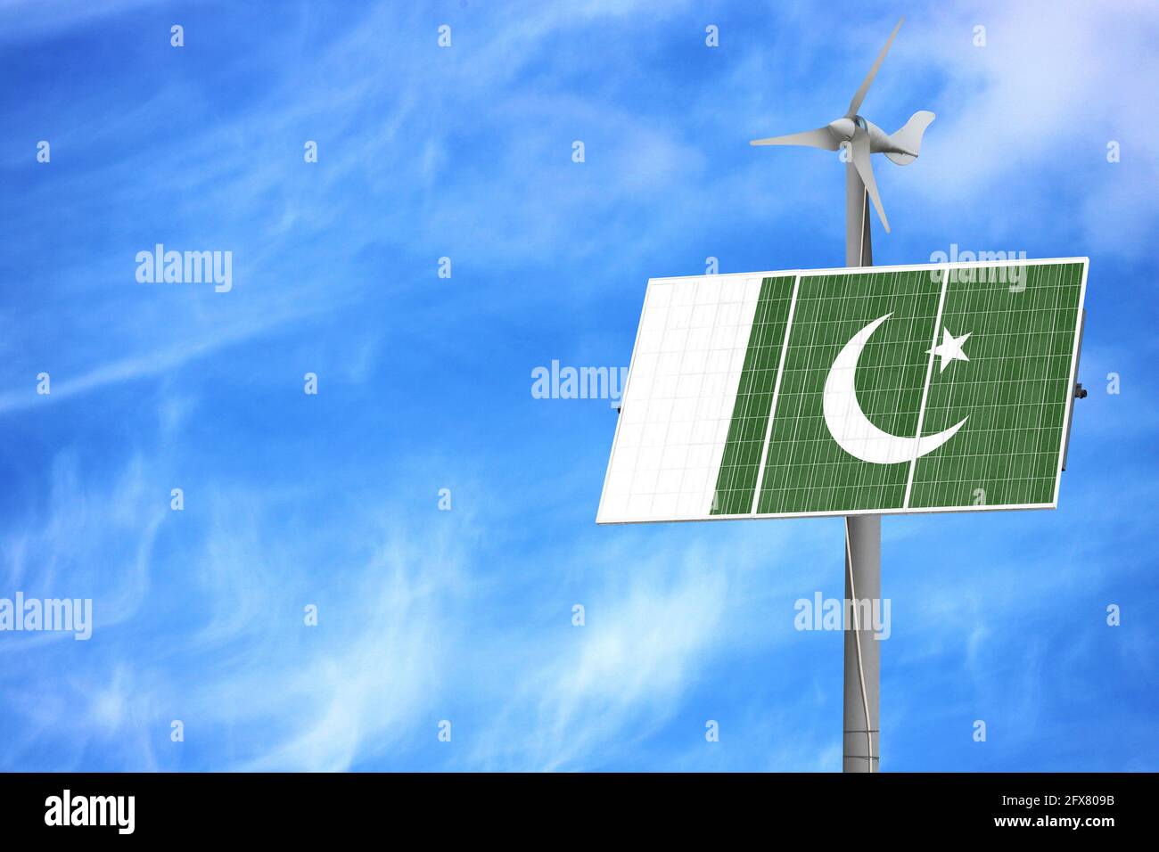 Solar panels against a blue sky with a picture of the flag of Pakistan ...