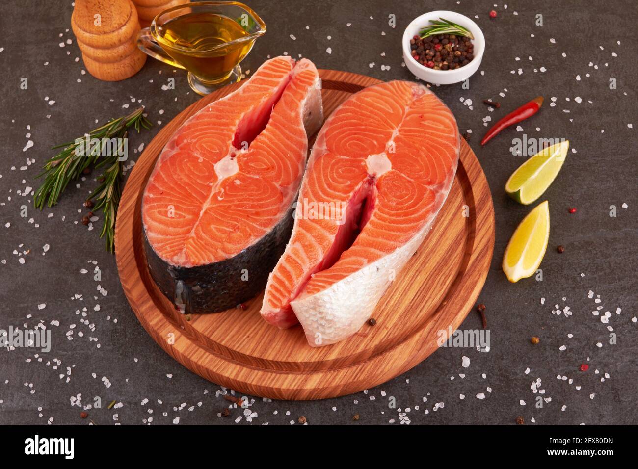Salmon steak on a black background with spices Stock Photo - Alamy