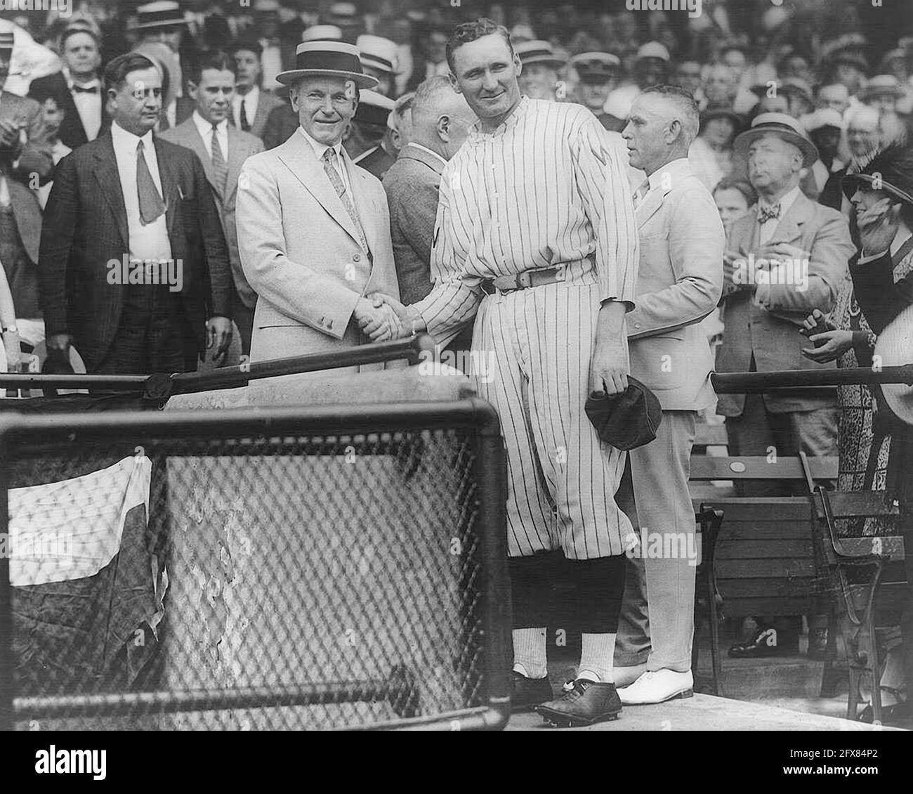 Walter Johnson, Washington Senators & Calvin Coolidge, President of the United States, shaking hands  at Griffith Stadium 1923. Stock Photo