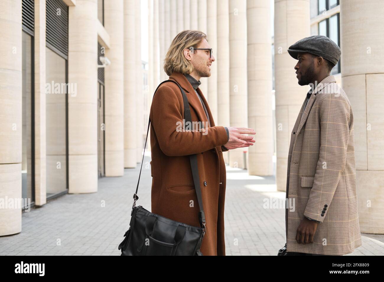 Young men talking during a meeting on the street Stock Photo