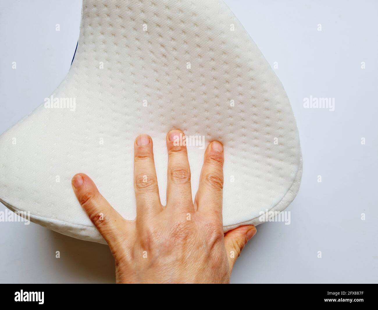 https://c8.alamy.com/comp/2FX887F/closeup-shot-of-a-hand-touching-a-white-memory-foam-knee-pillow-for-sleeping-isolated-in-white-2FX887F.jpg