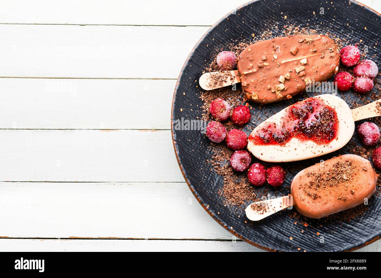 Popsicle ice cream with chocolate and cherry.Ice cream sticks.Copy space Stock Photo