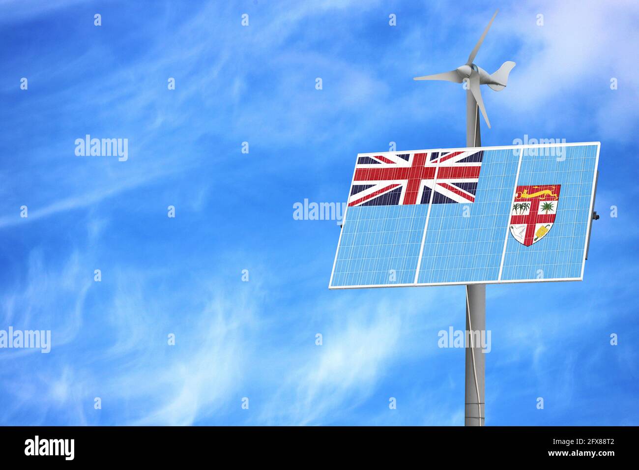 Solar panels against a blue sky with a picture of the flag of Fiji Stock Photo