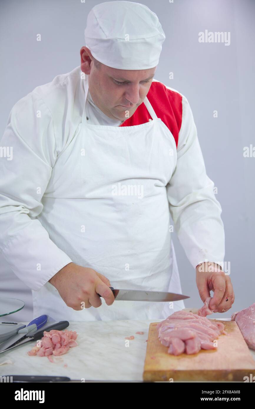Butcher Getting Shot Cutting with a wallpaper knife hi-res stock photography and images - Alamy