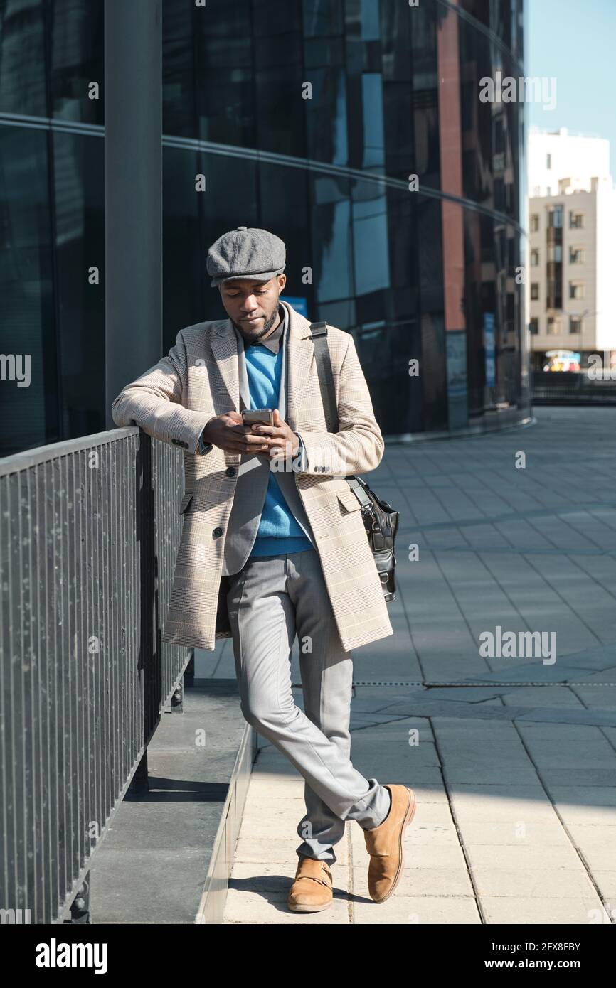 African businessman using smart phone while standing in the city Stock Photo