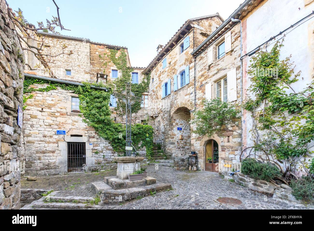 France, Ardeche, Cevennes National Park, Monts d'Ardeche Regional Natural  Park, Les Vans, Naves village, square with religious cross and typical  house Stock Photo - Alamy