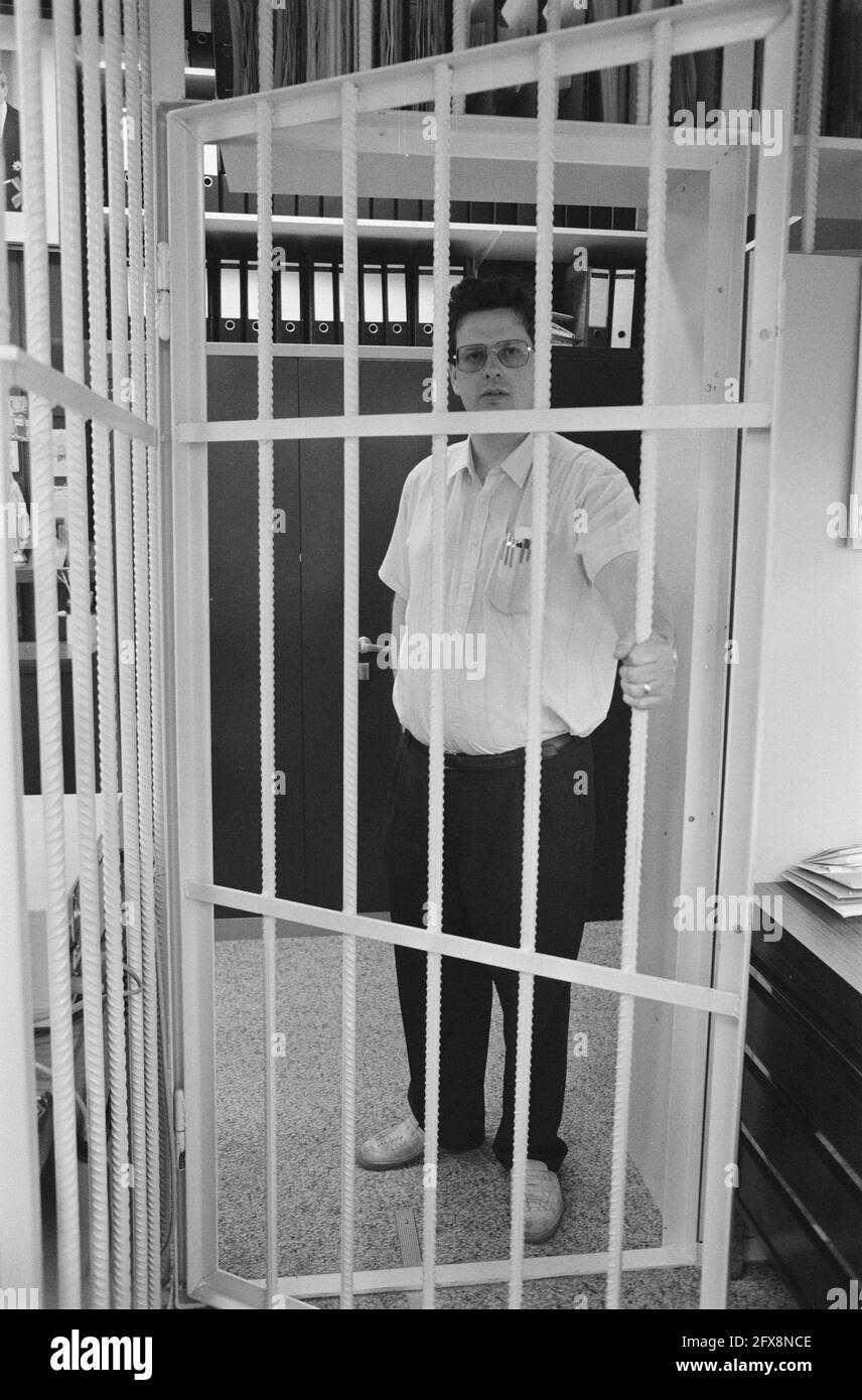 Guard poses behind barred door of a cell, April 14, 1989, vigilantes