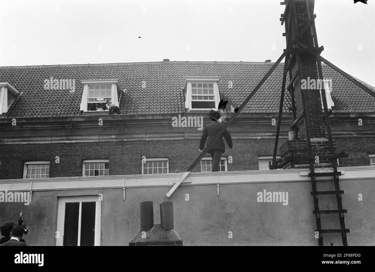 Occupation Maagdenhuis Amsterdam, by student police on roof Maagdenhuis, looking out the windows occupiers, 20 May 1969, POLICE, occupations, students, The Netherlands, 20th century press agency photo, news to remember, documentary, historic photography 1945-1990, visual stories, human history of the Twentieth Century, capturing moments in time Stock Photo