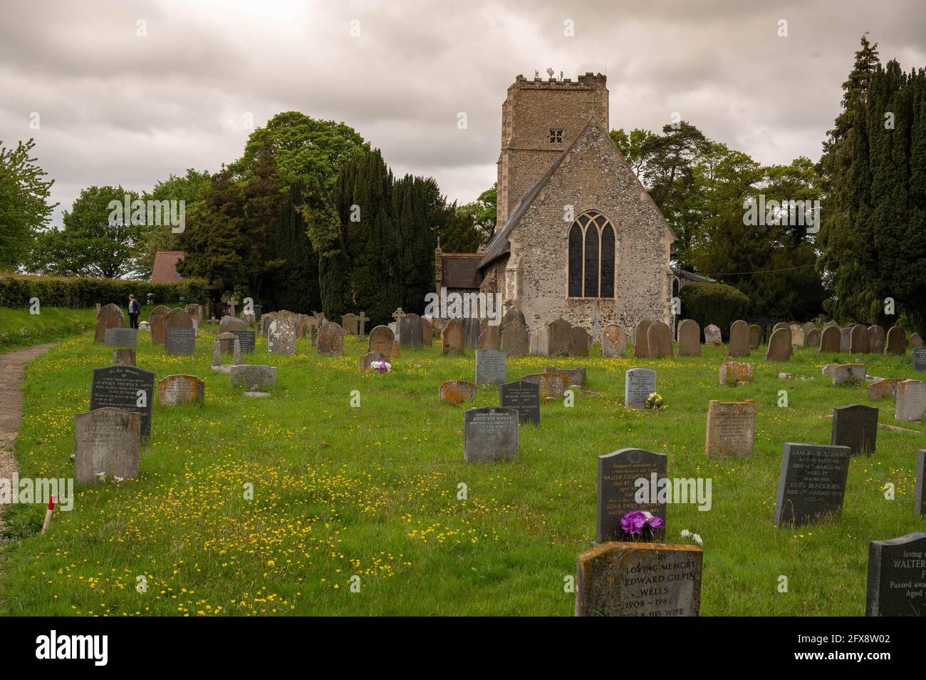 A Norfolk church with many old head stones in the graveyard. Stock Photo