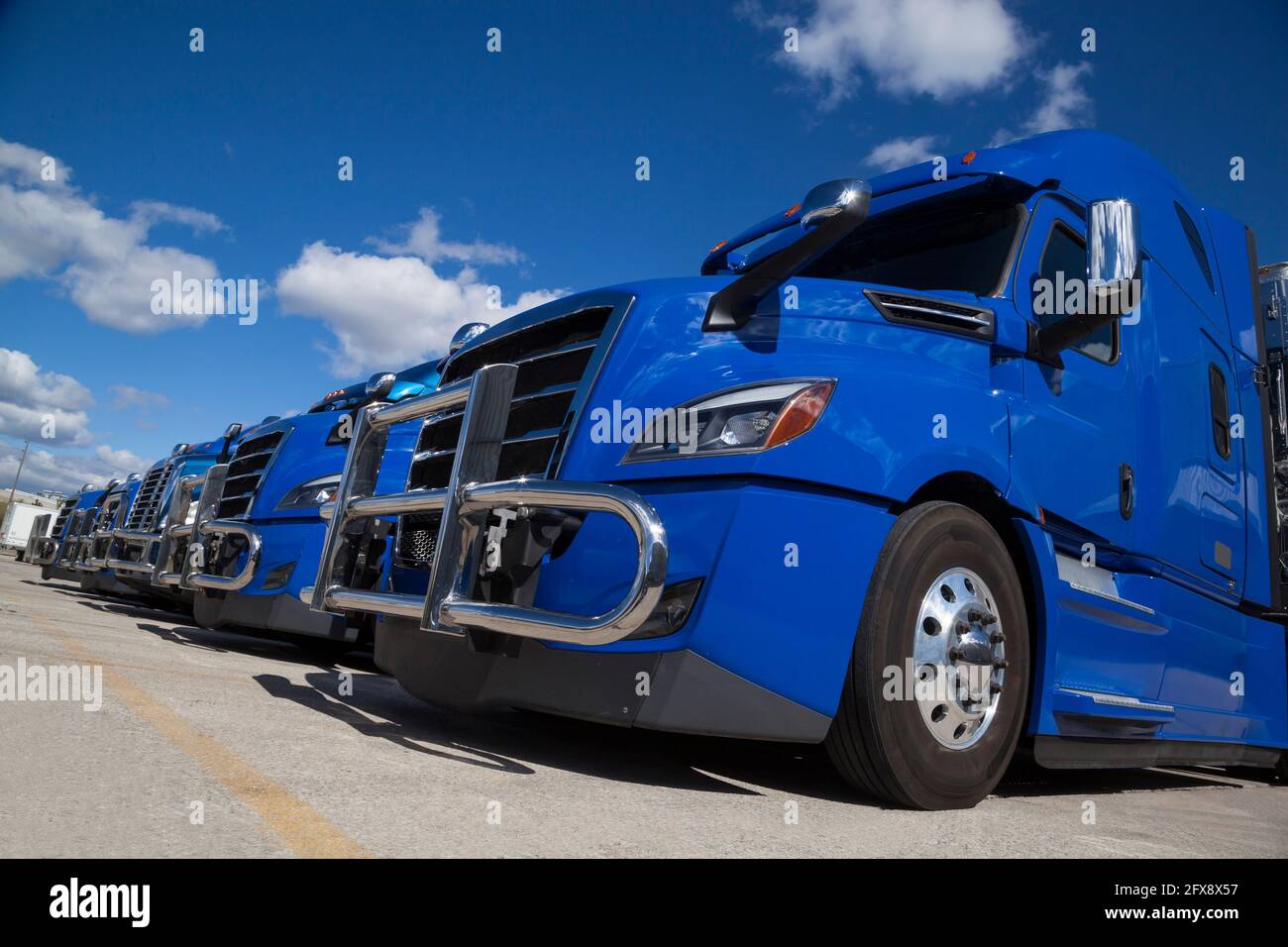 Blue Transport Trucks Lined Up in the Yard of a Warehouse Stock Photo ...