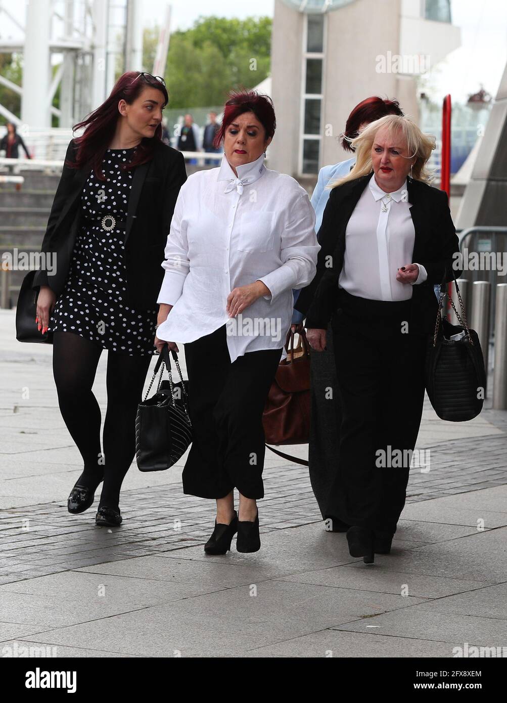 Jenny Hicks (front right) and Christine Burke (front left), relatives of victims of the Hilsborough leave the Lowry Theatre, Salford Quays, Greater Manchester, after a judge ruled there was no case to answer in the trial of two retired police officers, Alan Foster and Donald Denton, and retired solicitor Peter Metcalf, who were all accused of perverting the course of justice following the Hillsborough disaster on April 15, 1989. Picture date: Wednesday May 26, 2021. Stock Photo