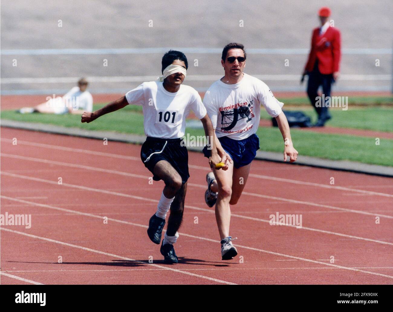 Disabled athletics blind runner and guide at Aldersley Stadium 1994. Parasport or disability sport. athlete athletes running partially sighted healthy exercise runners Britain Uk games sport sports Disability. Picture by DAVID BAGNALL Stock Photo