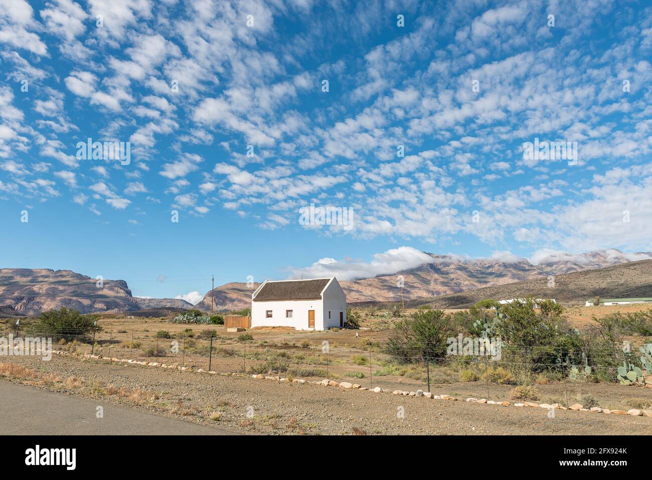 KLAARSTROOM, SOUTH AFRICA - APRIL 5, 2021: A house in Klaarstroom in the Western Cape Karoo. Meiringspoort is visible to the left as a break in the Sw Stock Photo