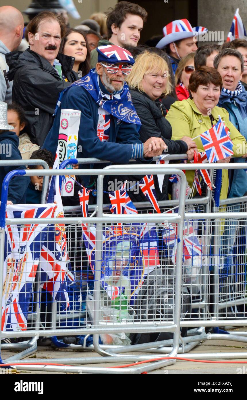 People waiting at the Queens Diamond Jubilee celebration in London, UK, hoping to catch a glimpse of the Queen and parade. Union Jack flags, hats Stock Photo